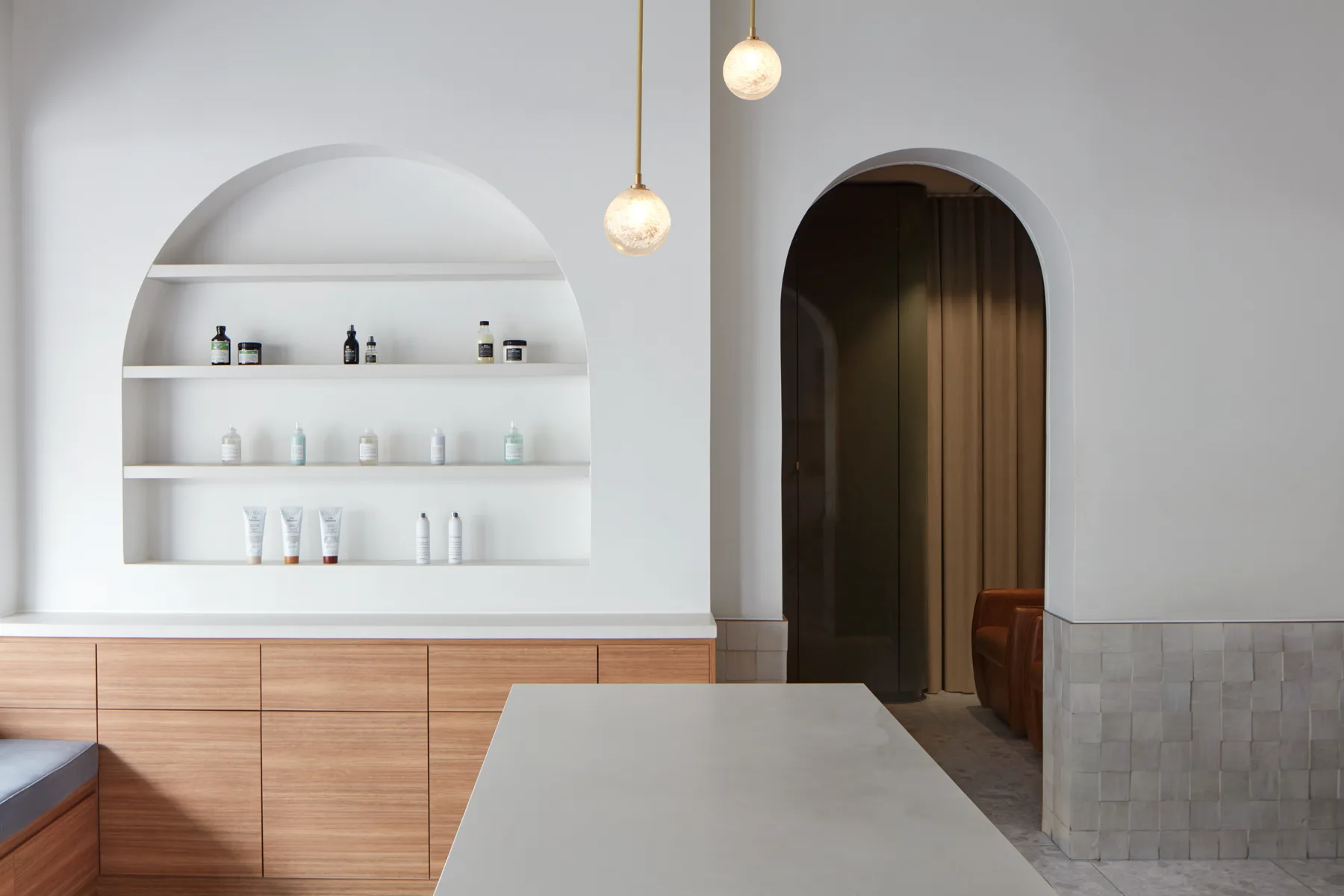 White arched Aveda product shelving at Frankie Salon