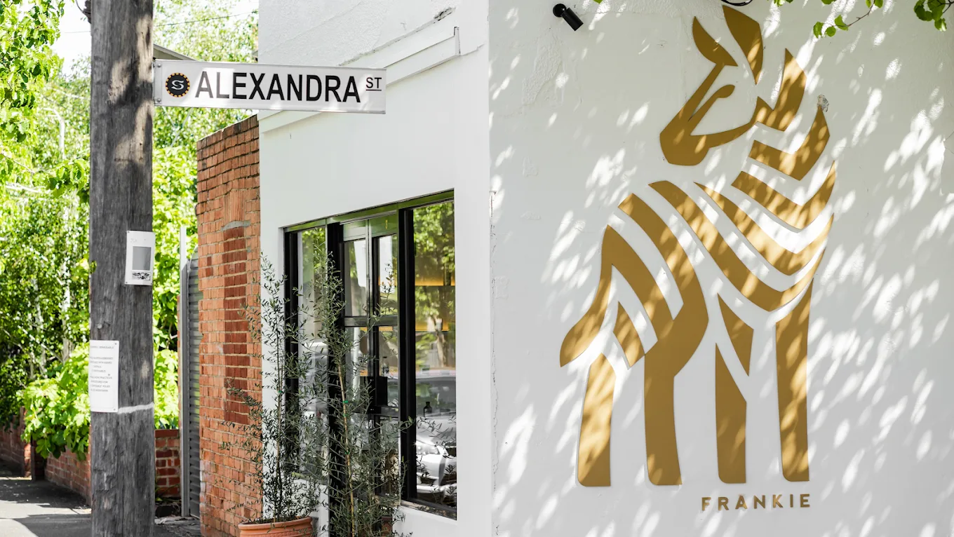 Frankie Salon South Yarra shopfront and gold FRANKIE zebra mural