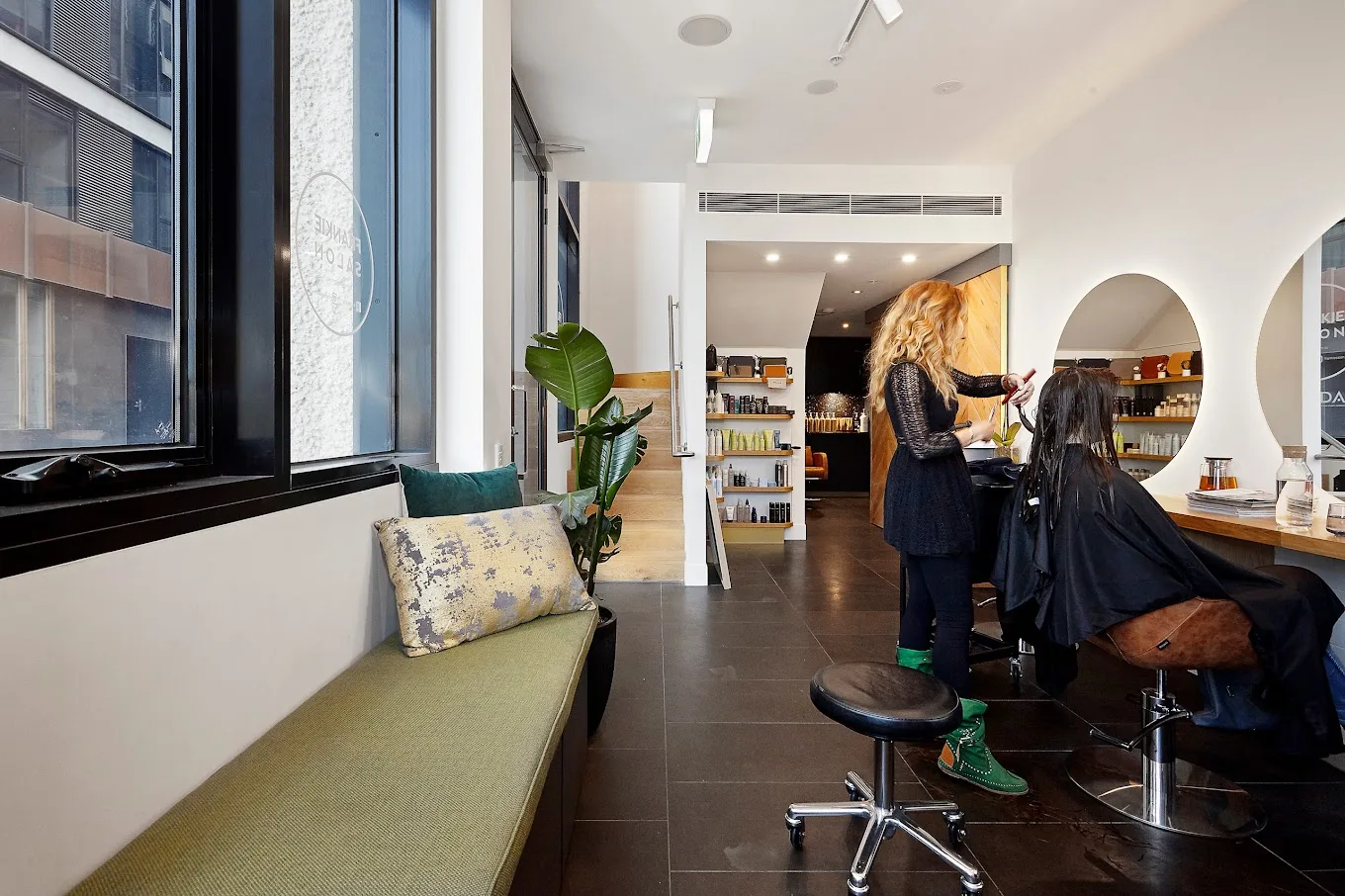 Richmond interior — window bench, client mid-service, product shelf